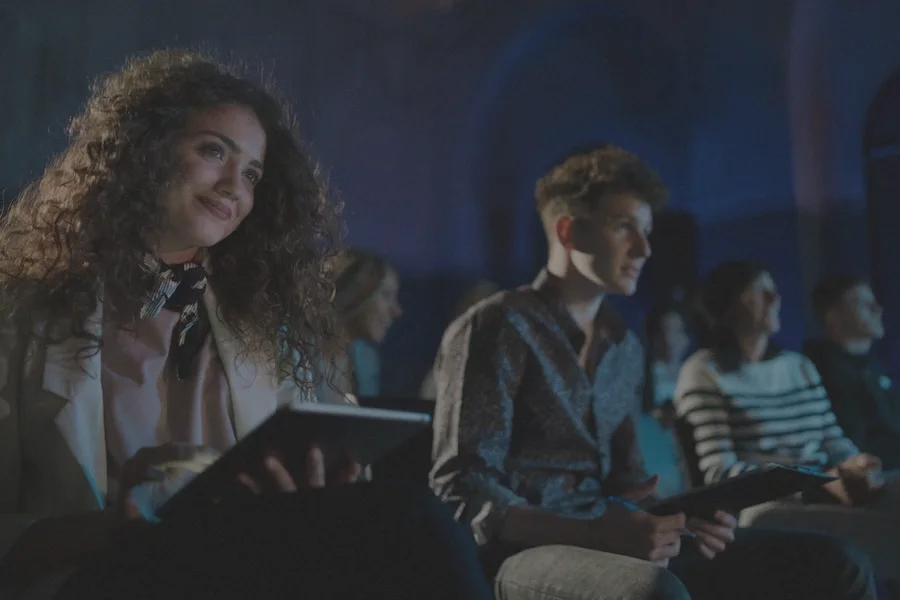 A delegate reading on a tablet during an evening session