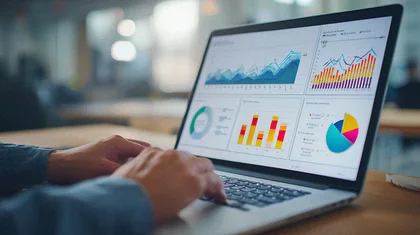 Analyst working through charts on a laptop